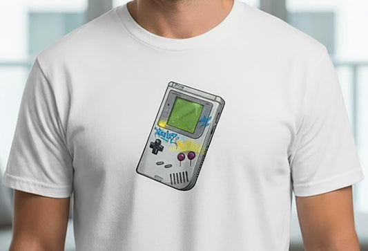 White t-shirt with a graphic of a handheld gaming device on a blurred indoor background
