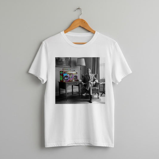 White t-shirt with a printed design of a person in a room listening to a graffiti covered ghetto blaster on a hanger against a gray background