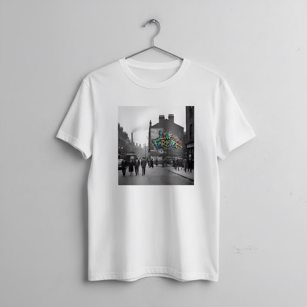 White t-shirt with a graphic of a city street scene and graffiti reading Live Forever on a hanger against a light gray background