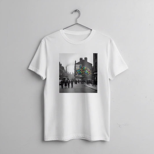 White t-shirt with a graphic of a city street scene and graffiti reading Live Forever on a hanger against a light gray background