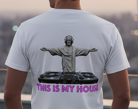 Person wearing a t-shirt with a graphic of a religious figure on a DJ setup and 'This is My House' text.